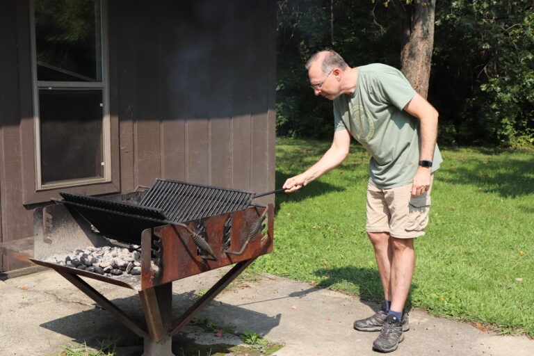 Dr. Marker grilling for staff & residents at All Clinic Retreat